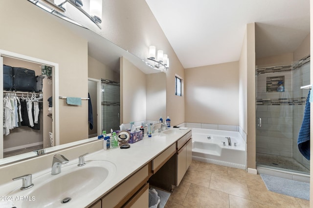 bathroom featuring tile patterned flooring, vanity, separate shower and tub, and vaulted ceiling