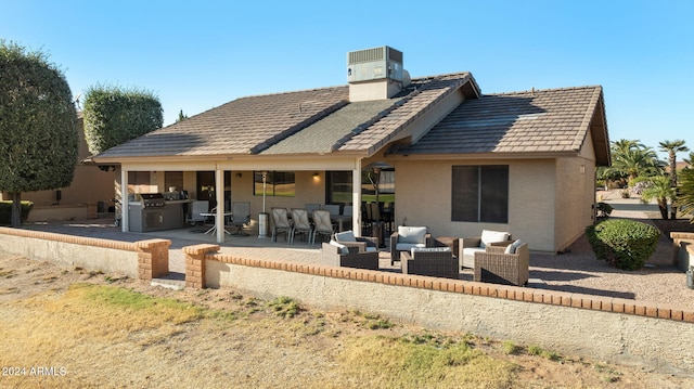 back of house featuring an outdoor living space, area for grilling, and a patio area