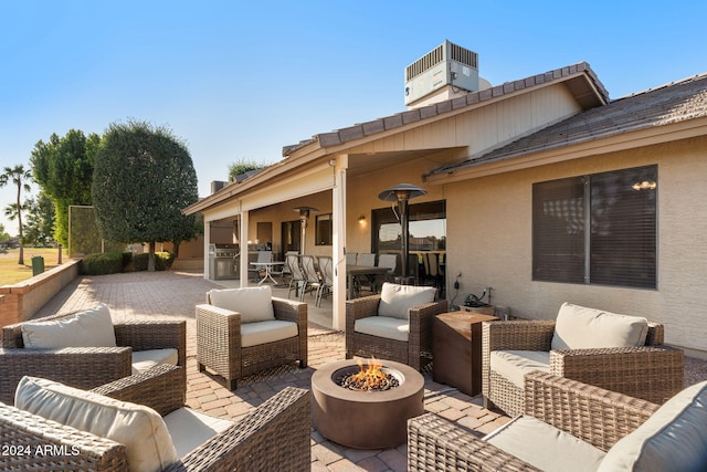 view of patio / terrace featuring an outdoor kitchen and a fire pit