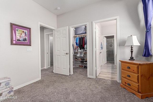 carpeted bedroom featuring connected bathroom and a closet