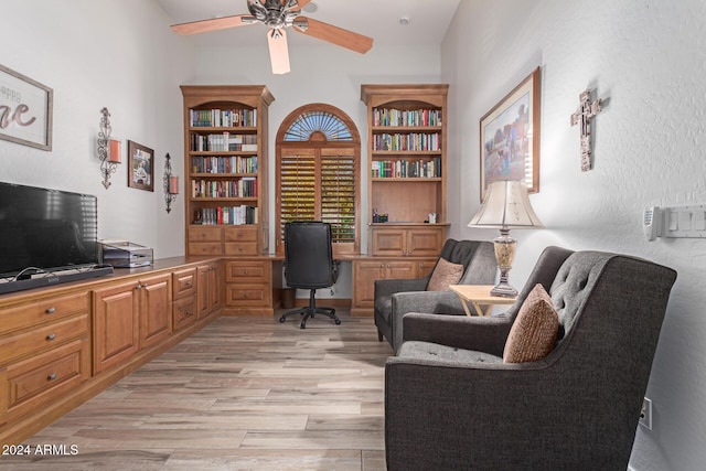 office space with ceiling fan, vaulted ceiling, and light wood-type flooring