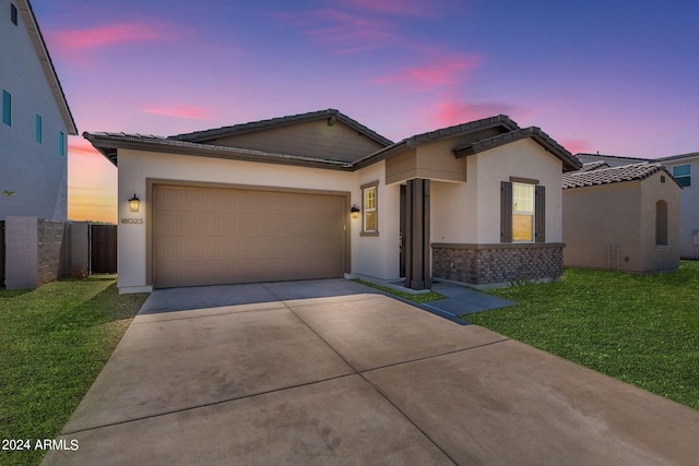 view of front facade featuring a yard and a garage