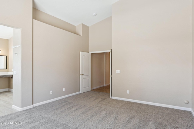 5010 W Ivanhoe St, Chandler, AZ 85226 - unfurnished bedroom with light carpet, baseboards, high vaulted ceiling, and ensuite bath