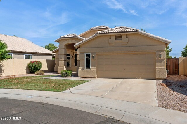 5010 W Ivanhoe St, Chandler, AZ 85226 - mediterranean / spanish-style home with a tiled roof, driveway, stucco siding, and fence