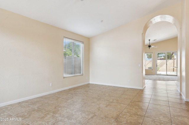 5010 W Ivanhoe St, Chandler, AZ 85226 - spare room featuring lofted ceiling, arched walkways, light tile patterned floors, baseboards, and a ceiling fan