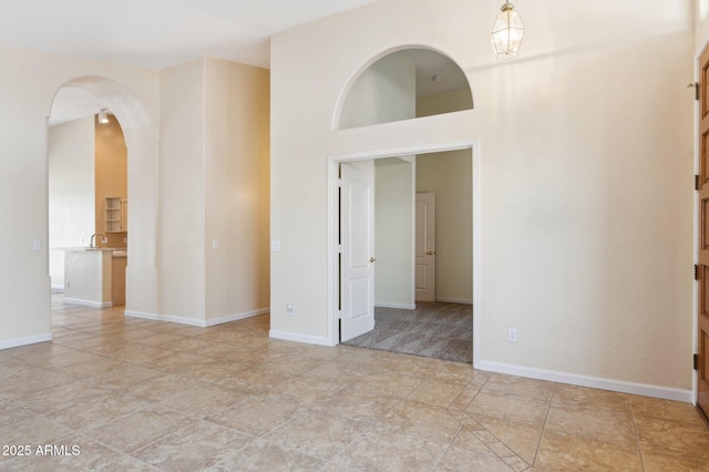 5010 W Ivanhoe St, Chandler, AZ 85226 - spare room featuring arched walkways, a high ceiling, and a sink
