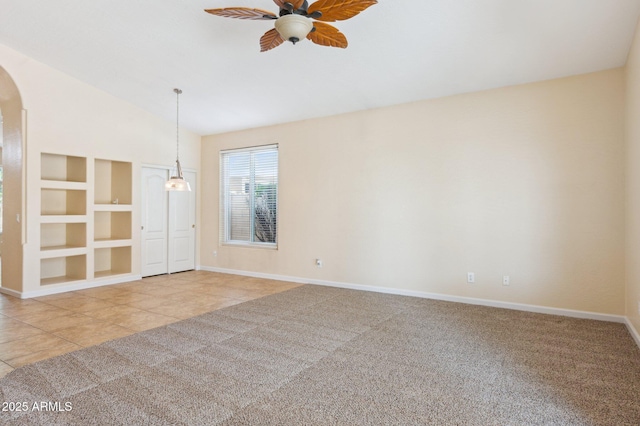 5010 W Ivanhoe St, Chandler, AZ 85226 - empty room with baseboards, built in shelves, a ceiling fan, arched walkways, and lofted ceiling