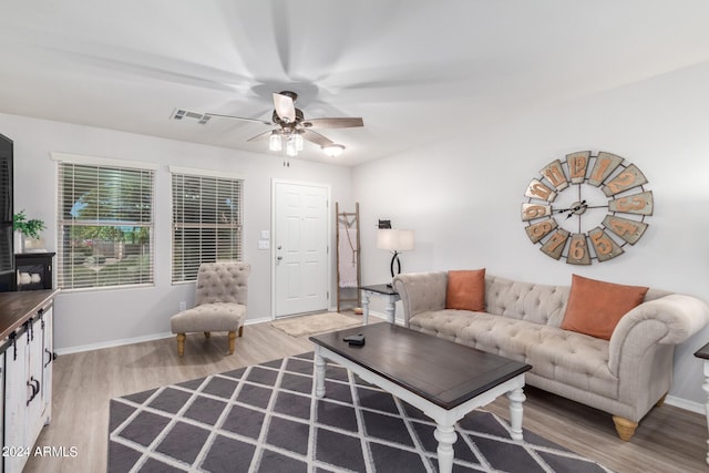 living room with light wood-type flooring and ceiling fan