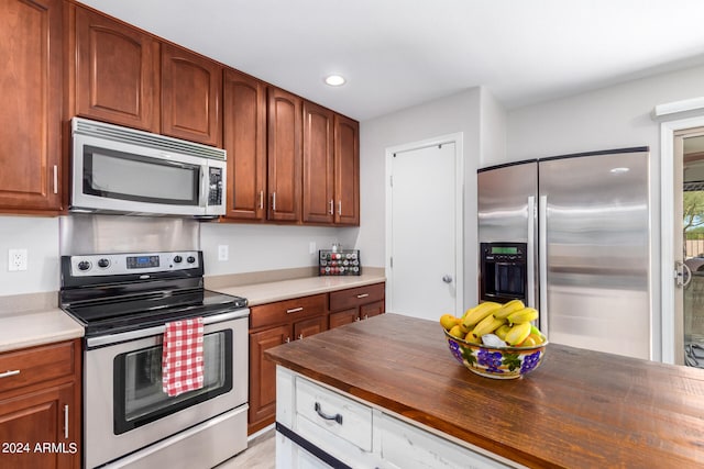 kitchen with stainless steel appliances and butcher block counters