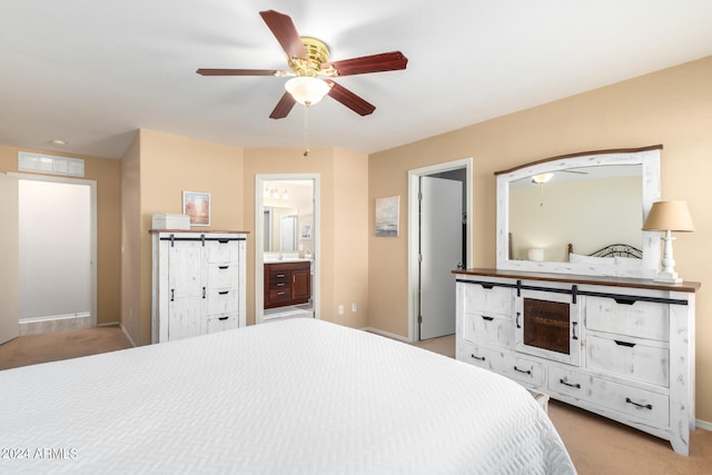 bedroom featuring ensuite bath, ceiling fan, and light colored carpet