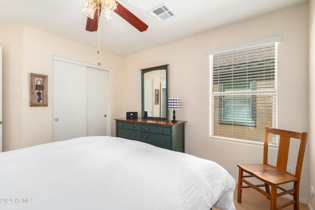 bedroom featuring ceiling fan, a closet, and carpet flooring