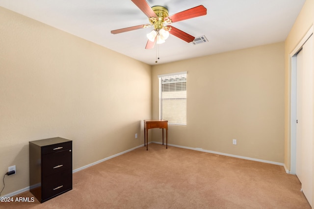 interior space featuring ceiling fan and light carpet