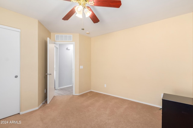 unfurnished room with ceiling fan and light colored carpet