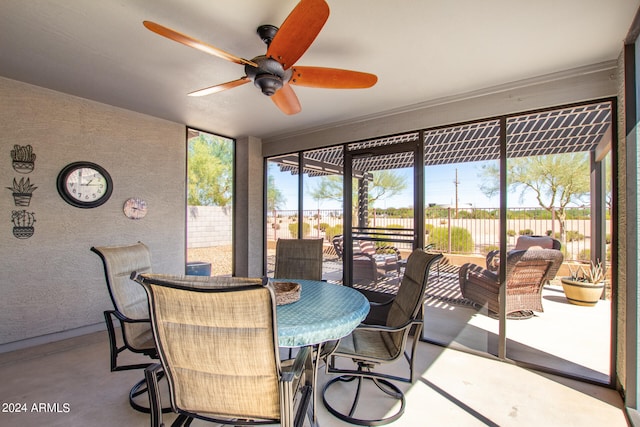 dining room with ceiling fan and concrete floors