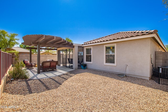 back of property featuring outdoor lounge area, a pergola, a patio area, and central air condition unit