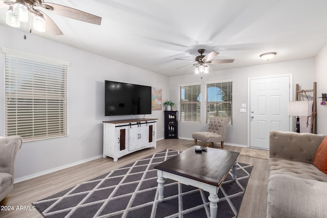 living room with hardwood / wood-style floors and ceiling fan