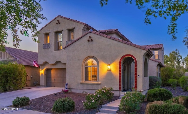 mediterranean / spanish home featuring a garage