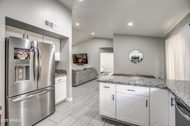 12543 W Roanoke Ave, Avondale, AZ 85392 - kitchen featuring stainless steel appliances, open floor plan, white cabinets, visible vents, and vaulted ceiling