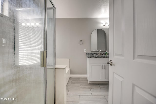 12543 W Roanoke Ave, Avondale, AZ 85392 - bathroom with vanity, a garden tub, and a shower stall