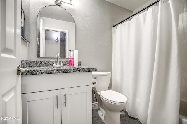 12543 W Roanoke Ave, Avondale, AZ 85392 - full bathroom with curtained shower, vanity, toilet, and a textured wall