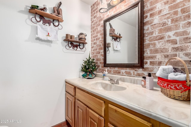 bathroom with brick wall and vanity