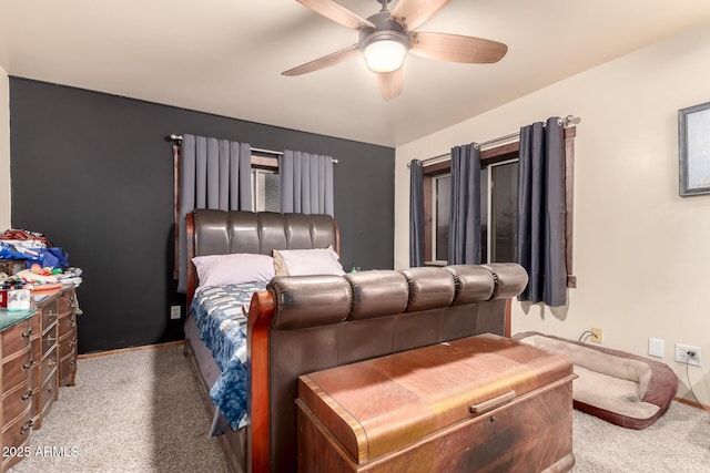 bedroom with a ceiling fan, carpet flooring, and baseboards