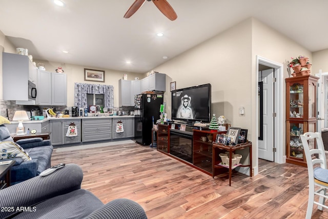 living area featuring recessed lighting, a ceiling fan, and light wood-style floors