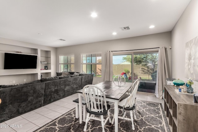 dining room with built in features and light tile patterned floors