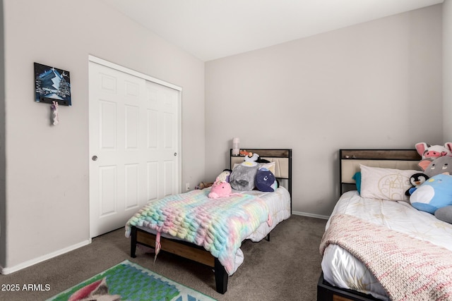 bedroom featuring a closet and dark colored carpet