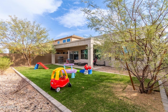 rear view of house with a yard, an outdoor hangout area, and a patio area