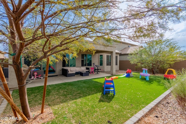 rear view of house featuring an outdoor living space, a yard, and a patio