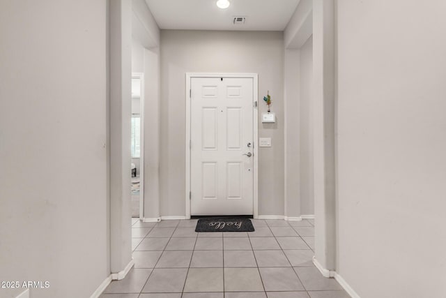 foyer entrance featuring light tile patterned flooring