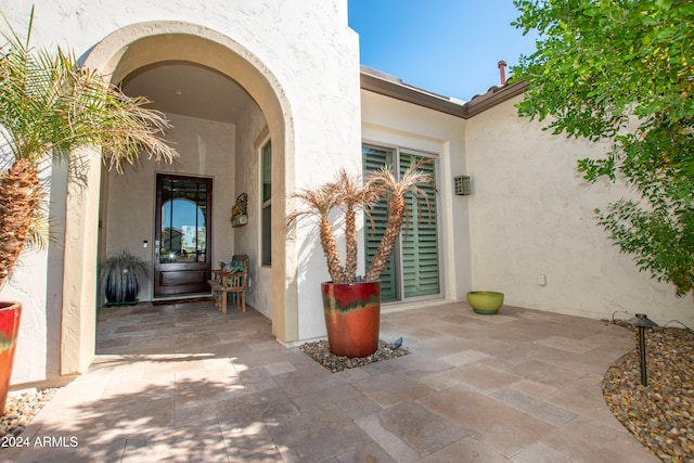 entrance to property with a patio