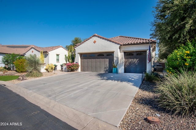 mediterranean / spanish-style home featuring a garage