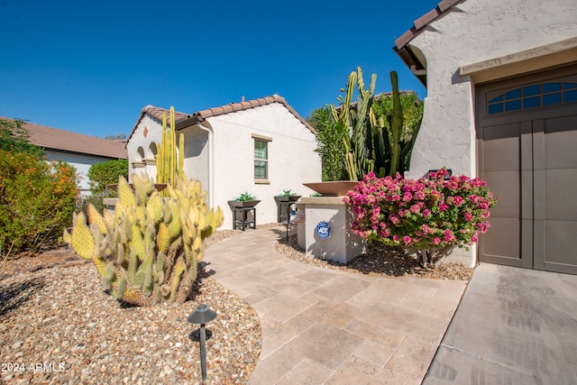 view of side of property featuring a patio area