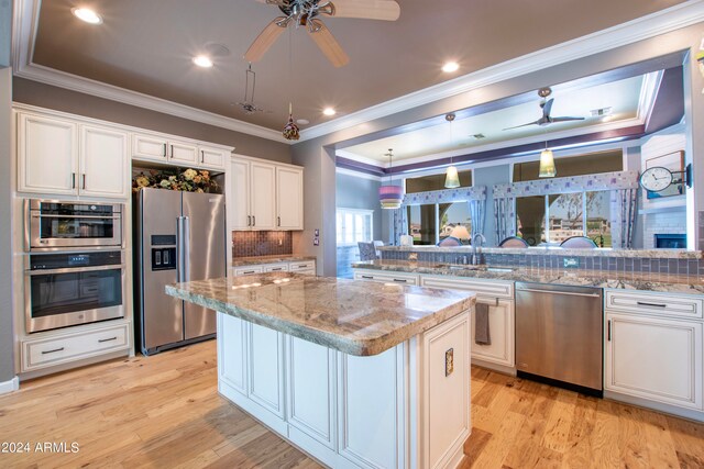 kitchen featuring tasteful backsplash, appliances with stainless steel finishes, and white cabinets