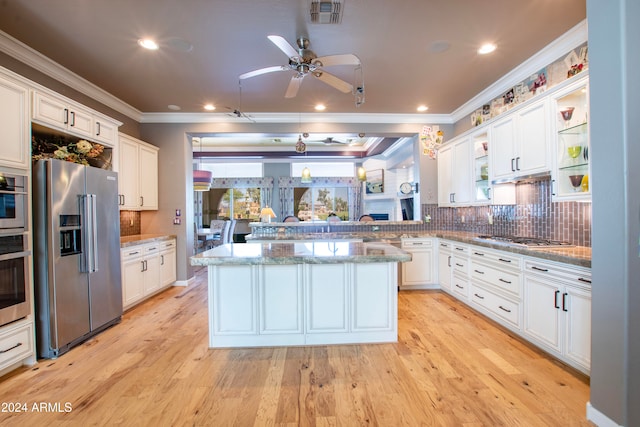 kitchen featuring a center island, appliances with stainless steel finishes, white cabinetry, and light wood-type flooring