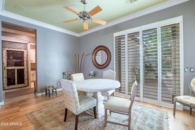 dining room with ornamental molding, light hardwood / wood-style flooring, and ceiling fan