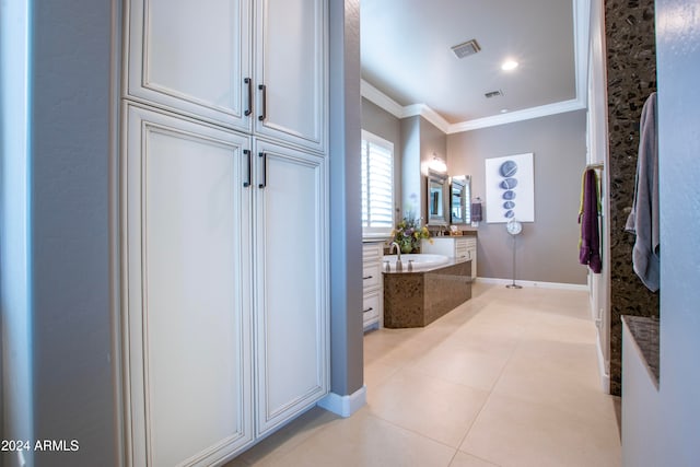 bathroom with vanity, ornamental molding, tiled tub, and tile patterned floors