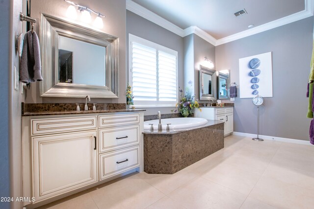 bathroom featuring vanity, tile patterned floors, ornamental molding, and tiled tub