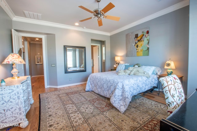 bedroom featuring ceiling fan, crown molding, and wood-type flooring