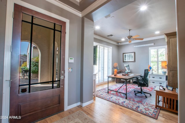 foyer entrance with light hardwood / wood-style floors, crown molding, and ceiling fan