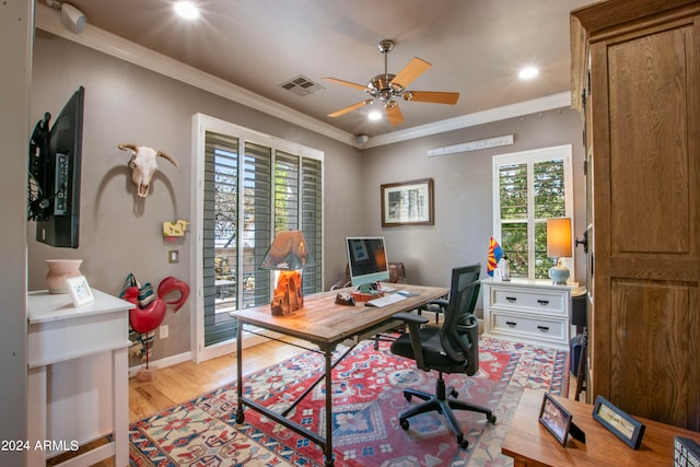 home office featuring crown molding, light wood-type flooring, a healthy amount of sunlight, and ceiling fan