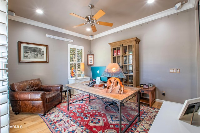 office area featuring crown molding, light hardwood / wood-style floors, and ceiling fan