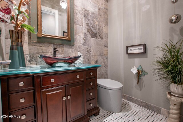 bathroom with vanity, toilet, and tile patterned floors