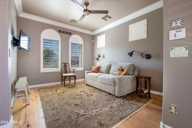 living room with ornamental molding, hardwood / wood-style floors, and ceiling fan