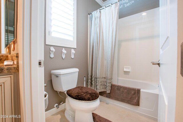 full bathroom with vanity, toilet, tile patterned floors, and shower / bath combo with shower curtain