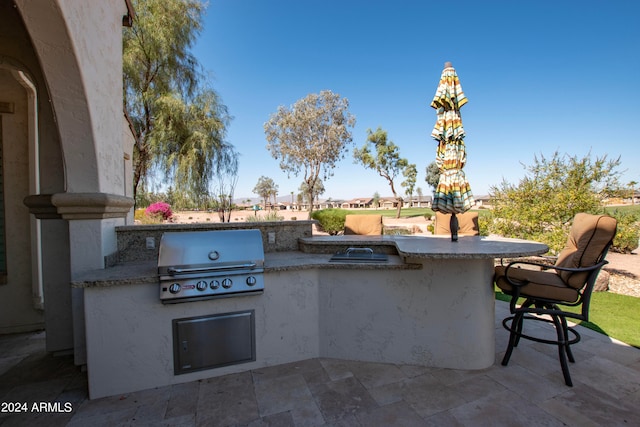 view of patio / terrace featuring grilling area and an outdoor kitchen