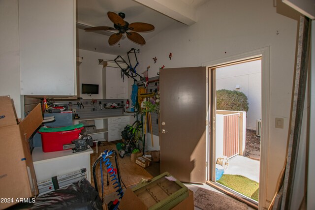 interior space with beamed ceiling and ceiling fan