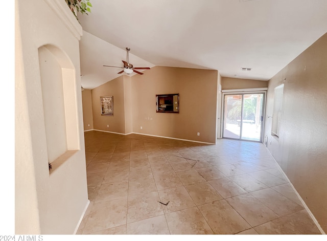 tiled spare room with ceiling fan and vaulted ceiling